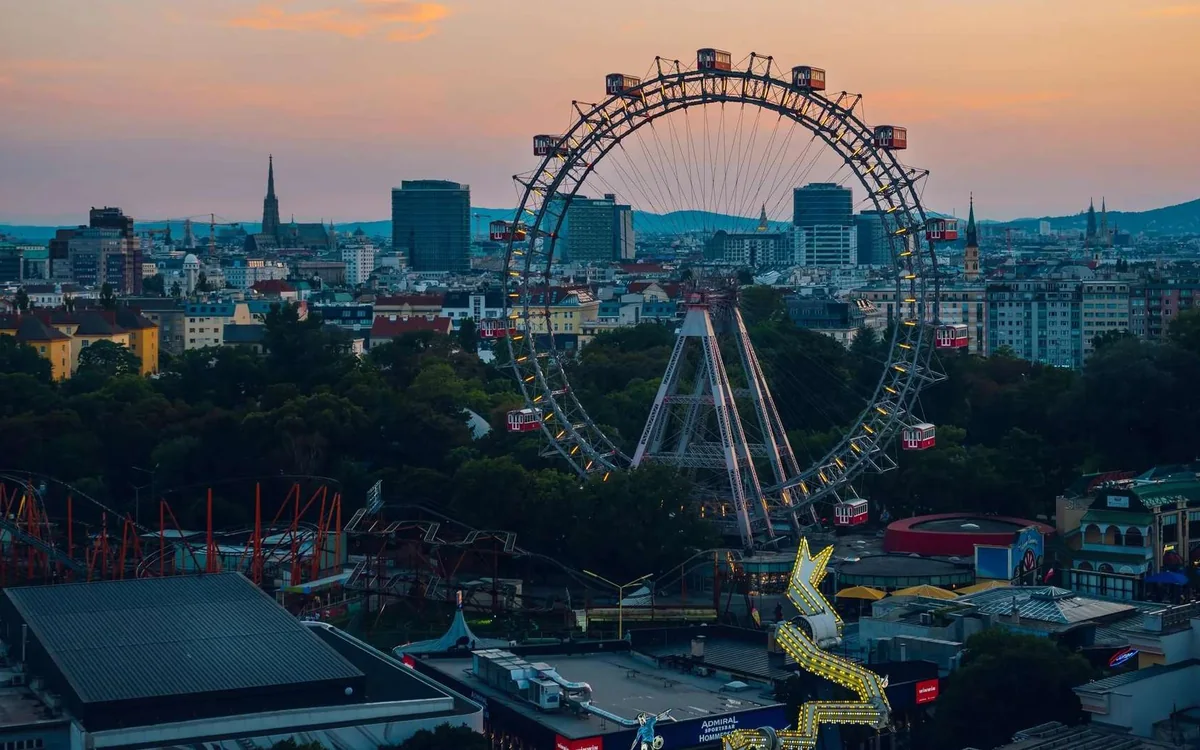 The Giant Ferris Wheel at dusk above the rooftops of the Prater
