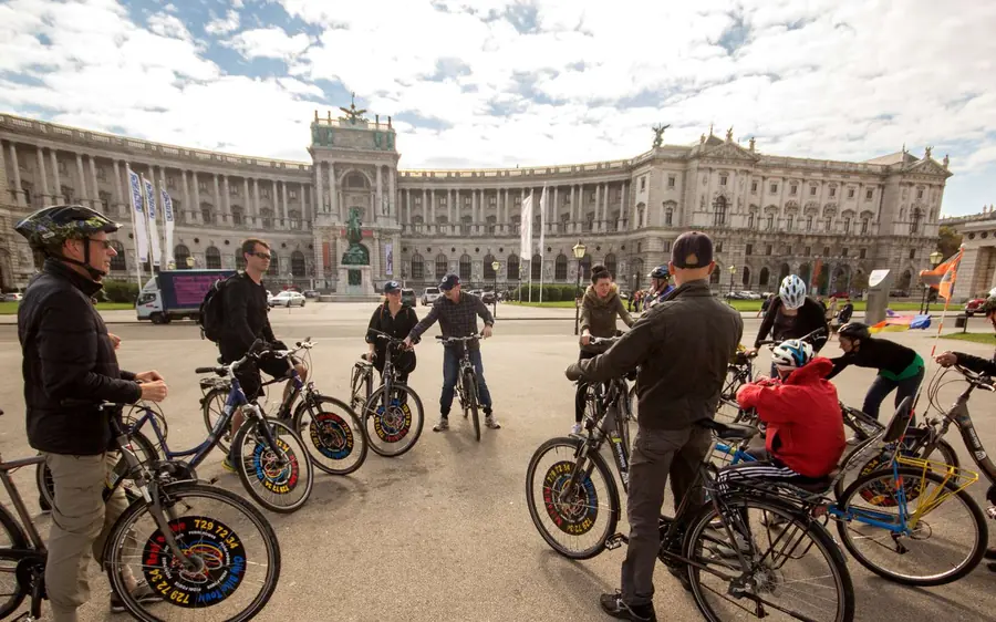 Riders with their bikes on the square in front of the Hofburg