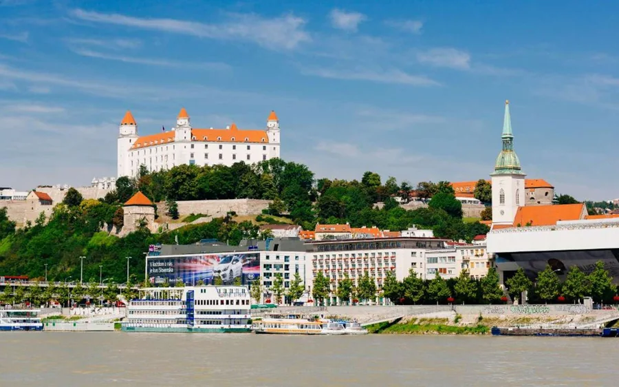 Bratislava Castle and a church tower seen from the Danube