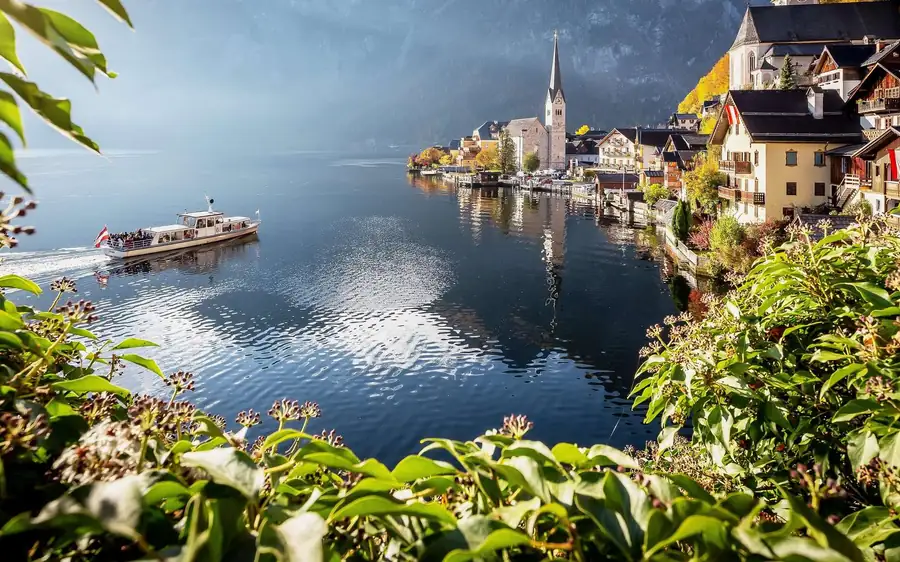 A boat on Lake Hallstatt with the village church behind