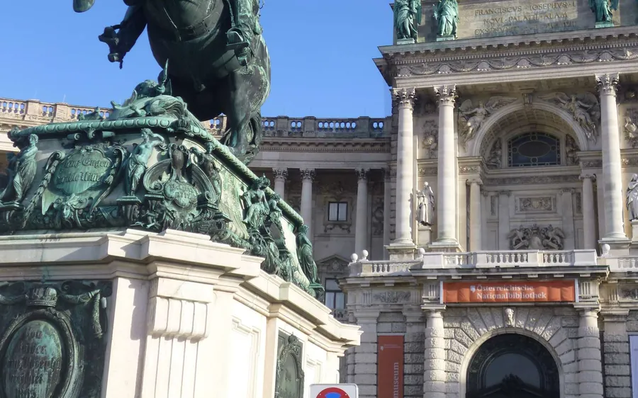 An equestrian statue in front of the columns of the Hofburg