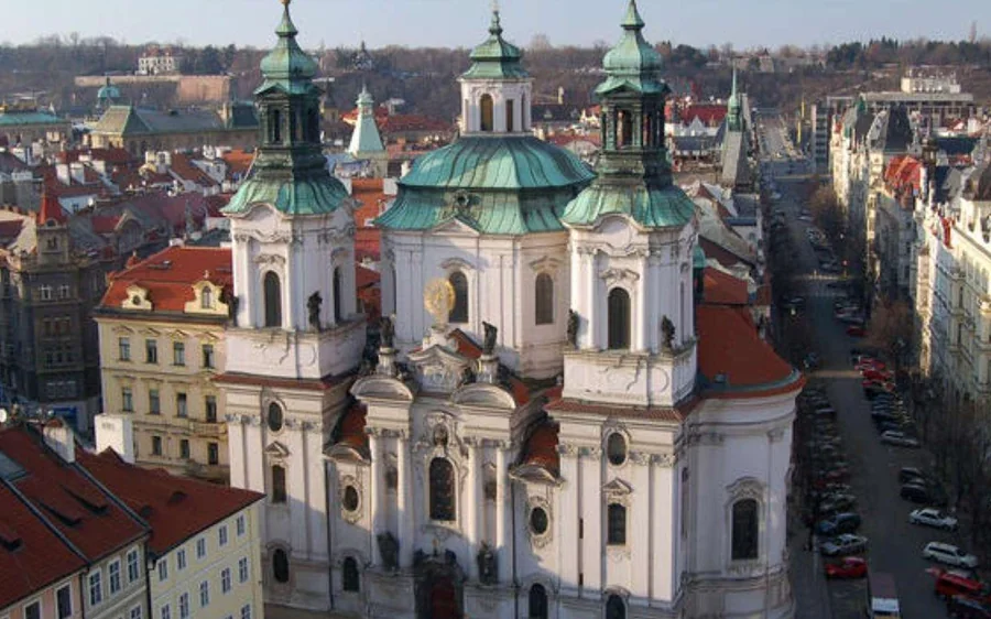 Green baroque domes and red rooftops of Prague seen from above
