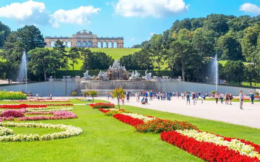 Schönbrunn gardens and fountain with the Gloriette on the hill behind