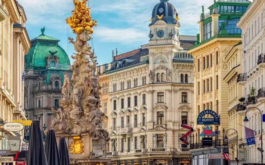 A gilded baroque column on the Graben between grand buildings