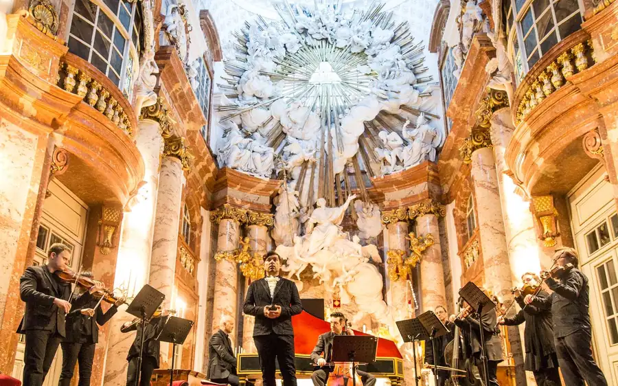 Musicians playing in front of the gilded altar of Karlskirche