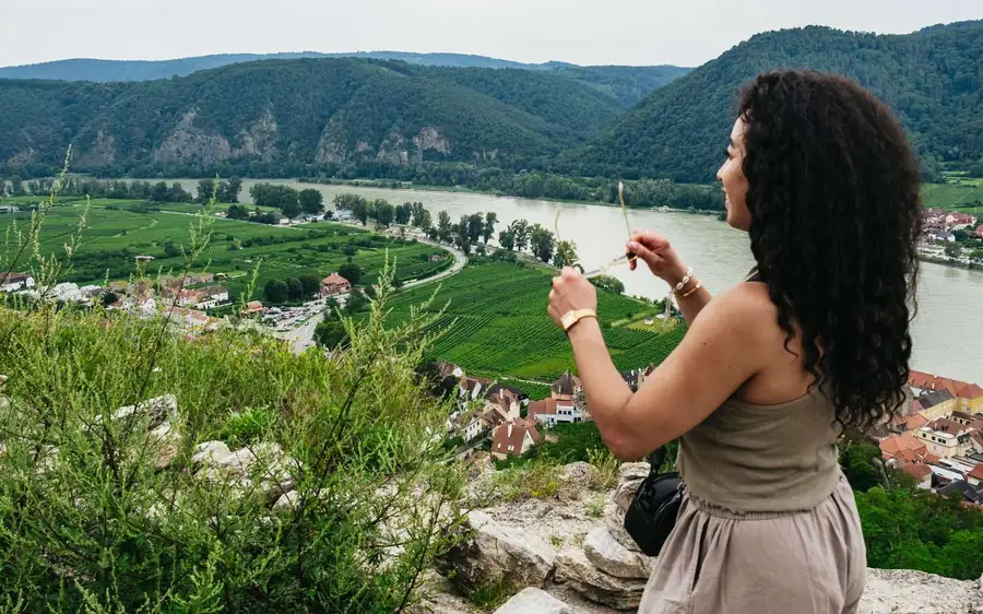 A visitor looking over vineyards and the Danube in the Wachau Valley